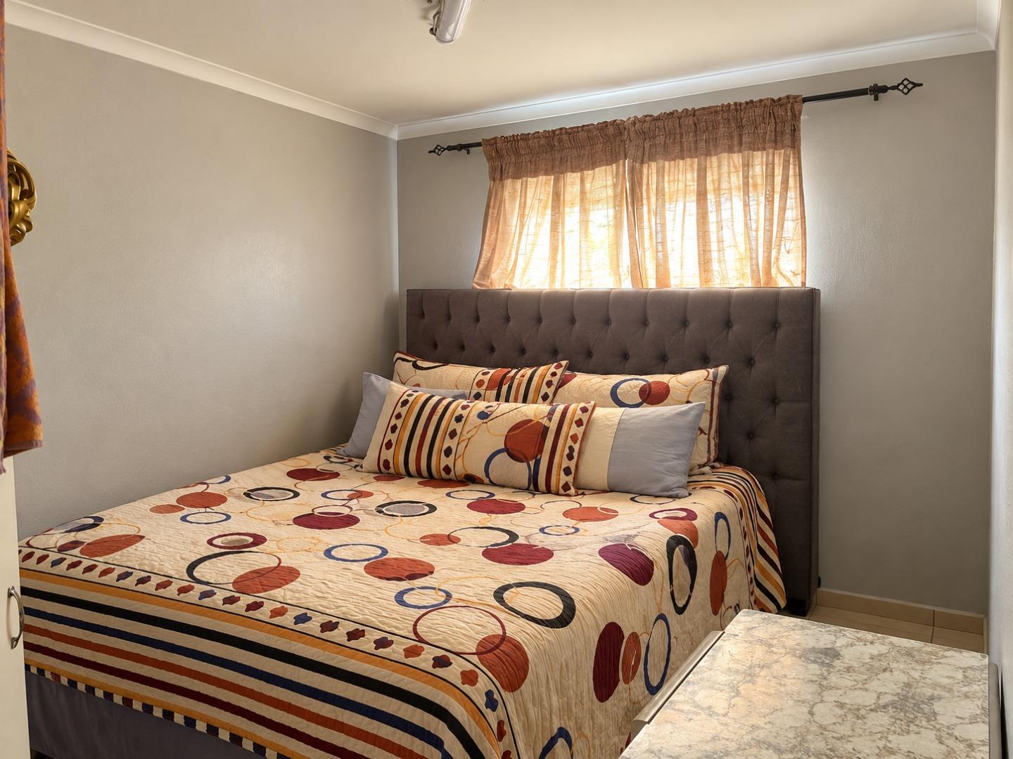 769718_Cozy_Tufted_Bedroom_with_Patterned_Bedding.jpg
